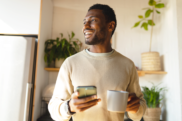 man holding a mug and smiling